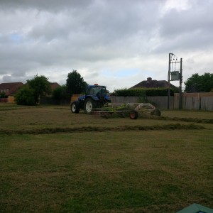 Grass raking with tractor